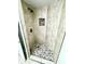 An alcove shower has decorative tiled walls and floor, plus bronze shower head and valve at 3621 Atrium Dr # U-4, Orlando, FL 32822