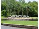 Community entrance with the 'Ventura' sign and palm trees surrounded by a pond at 3621 Atrium Dr # U-4, Orlando, FL 32822