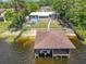 Aerial view of waterfront property with boat dock, boat lift, outdoor space, and fenced-in backyard at 3788 N Econlockhatchee Trl, Orlando, FL 32817