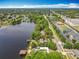 Aerial view showcases waterfront property with boat dock, serene lake, and lush green surroundings at 3788 N Econlockhatchee Trl, Orlando, FL 32817