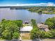 Aerial view highlighting a home with water access, dock, and mature trees at 3788 N Econlockhatchee Trl, Orlando, FL 32817