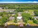 Aerial shot features waterfront home with boat dock and pool, surrounded by trees at 3788 N Econlockhatchee Trl, Orlando, FL 32817