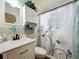 Bathroom features decorative shower curtain, vanity with sink, and large wall mirror at 3788 N Econlockhatchee Trl, Orlando, FL 32817