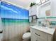 Bright bathroom with beach themed shower curtain, white sink vanity and tile flooring at 3788 N Econlockhatchee Trl, Orlando, FL 32817