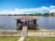Waterfront property featuring a covered boat dock with a boat lift, perfect for lake enthusiasts at 3788 N Econlockhatchee Trl, Orlando, FL 32817