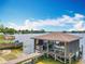 Lake view featuring a covered boat dock with boat lift, offering both convenience and picturesque scenery at 3788 N Econlockhatchee Trl, Orlando, FL 32817