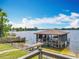 Lake view featuring a covered boat dock with boat lift, seamlessly blending nature with functional design at 3788 N Econlockhatchee Trl, Orlando, FL 32817