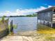 Waterfront boat ramp with a covered boat dock, offering direct access to the serene lake at 3788 N Econlockhatchee Trl, Orlando, FL 32817