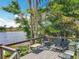 Relax on the outdoor deck, overlooking a tranquil lake surrounded by lush greenery at 3788 N Econlockhatchee Trl, Orlando, FL 32817