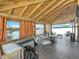 Covered boat dock featuring lake view and outdoor seating with overhead wood beams at 3788 N Econlockhatchee Trl, Orlando, FL 32817