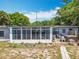Back exterior of the house with sunroom, hot tub, above ground pool, and large yard at 3788 N Econlockhatchee Trl, Orlando, FL 32817