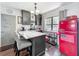 Stylish kitchen with a breakfast bar, a red retro refrigerator, sleek cabinetry, and modern appliances at 3788 N Econlockhatchee Trl, Orlando, FL 32817
