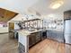 Open concept kitchen with an island, granite countertops, stainless steel appliances, and hardwood floors at 3788 N Econlockhatchee Trl, Orlando, FL 32817