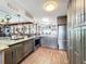 Modern kitchen with dark cabinetry, granite countertops, stainless steel appliances, and hardwood floors at 3788 N Econlockhatchee Trl, Orlando, FL 32817