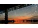 Relaxing water view with string lights, showcasing an orange sunset and tranquil lake reflection at 3788 N Econlockhatchee Trl, Orlando, FL 32817