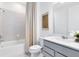 Well-lit bathroom featuring a shower-tub combo, a modern vanity, and a neutral color palette at 4007 Marbury Ct, Davenport, FL 33837