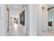 Bright hallway featuring modern lighting and contemporary artwork, leading to various rooms at 4007 Marbury Ct, Davenport, FL 33837