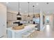 Modern kitchen with stainless steel appliances, center island with seating, and ample cabinet space at 4007 Marbury Ct, Davenport, FL 33837