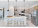 Beautiful kitchen with stainless steel appliances, a center island, and contemporary lighting at 4007 Marbury Ct, Davenport, FL 33837
