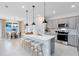 Stylish kitchen with stainless steel appliances, a center island, and modern pendant lighting at 4007 Marbury Ct, Davenport, FL 33837