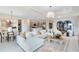 Open-concept living room and kitchen with a large sectional sofa and neutral tones and decor at 4007 Marbury Ct, Davenport, FL 33837
