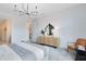 Bright and airy main bedroom with stylish decor, including a modern chandelier and a cozy sitting area at 4007 Marbury Ct, Davenport, FL 33837