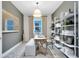 Home office with shelving, a desk, a comfortable chair, and a view of the outdoors at 4007 Marbury Ct, Davenport, FL 33837