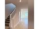 View of the neutral-toned entryway featuring a staircase and ceramic tile floors at 4433 Sagefield Dr, St Cloud, FL 34773