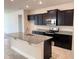 Kitchen featuring a center island with granite countertops, stainless steel appliances, and dark cabinetry at 4433 Sagefield Dr, St Cloud, FL 34773
