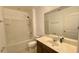 Clean bathroom with a tub and shower combination, a vanity with a large mirror, and tile flooring at 4450 Capital Blvd, St Cloud, FL 34769