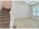 Carpeted staircase with white railing leads to the upper level, providing a clear view of the home's layout at 4450 Capital Blvd, St Cloud, FL 34769
