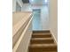 Carpeted stairs with white railing lead to the upper level, enhancing the home's interior design at 4450 Capital Blvd, St Cloud, FL 34769
