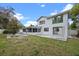 The backyard boasts a screened-in patio, a concrete patio, and is surrounded by lush trees for privacy at 4527 Sandhurst Dr, Orlando, FL 32817