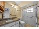 Bathroom featuring granite counters, a glass-enclosed shower, and updated fixtures at 4527 Sandhurst Dr, Orlando, FL 32817