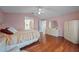 Comfortable bedroom featuring a ceiling fan and gleaming hardwood floors at 4527 Sandhurst Dr, Orlando, FL 32817