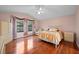 Tranquil main bedroom featuring hardwood floors, a ceiling fan, and ample natural light at 4527 Sandhurst Dr, Orlando, FL 32817