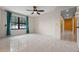 Bright bedroom featuring neutral walls, tile flooring, a window, and a doorway that leads to a hallway at 4527 Sandhurst Dr, Orlando, FL 32817