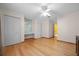 Bright bedroom featuring hardwood floors, a ceiling fan, and ample closet space at 4527 Sandhurst Dr, Orlando, FL 32817