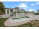 A side view of a charming two-story home featuring a well-manicured lawn and brick patio at 4527 Sandhurst Dr, Orlando, FL 32817