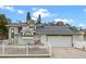 Charming two-story home featuring a well-manicured lawn and white picket fence, complemented by an attached two-car garage at 4527 Sandhurst Dr, Orlando, FL 32817