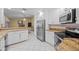 Modern kitchen featuring stainless steel appliances and breakfast bar overlooking the living room at 4527 Sandhurst Dr, Orlando, FL 32817