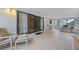 A sunroom with tile flooring, lots of natural light, and comfortable seating arrangements with large sliding glass doors at 4527 Sandhurst Dr, Orlando, FL 32817