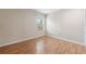 An empty bedroom features wood floors and a single window at 5071 Eaglesmere Dr # C01, Orlando, FL 32819