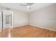 A well-lit bedroom with laminate flooring, a ceiling fan, and a neutral color palette at 5071 Eaglesmere Dr # C01, Orlando, FL 32819