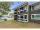 The exterior view of the house featuring a lawn and a balcony at 5071 Eaglesmere Dr # C01, Orlando, FL 32819