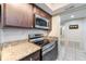Modern kitchen with stainless steel appliances and light granite countertops at 5071 Eaglesmere Dr # C01, Orlando, FL 32819