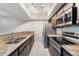 Modern kitchen featuring granite countertops, stainless steel appliances, and tiled floors at 5071 Eaglesmere Dr # C01, Orlando, FL 32819