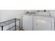 Functional laundry room features a washer, dryer, and shelving at 5071 Eaglesmere Dr # C01, Orlando, FL 32819