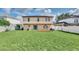Large, fenced backyard view of the home's rear exterior featuring a sliding glass door at 510 Lobelia Dr, Davenport, FL 33837