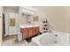 Bathroom featuring double vanity and soaking tub at 510 Lobelia Dr, Davenport, FL 33837